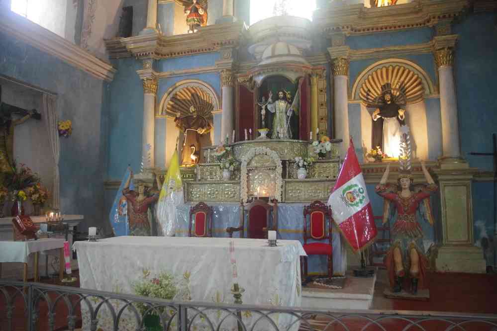 Intérieur de l’église de Yanque. Les drapeaux péruvien et du Vatican traduisent l’absence de séparation entre l’église et l’état au Pérou, le 6 août 2024